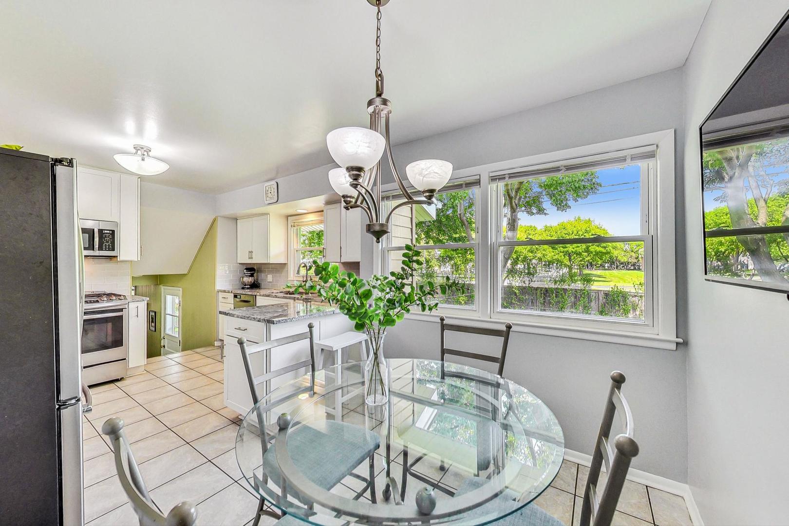 910 Whitegate Drive Mount Prospect, IL 60056 - Photo 15 of 38 a view of a dining room with furniture window and outside view