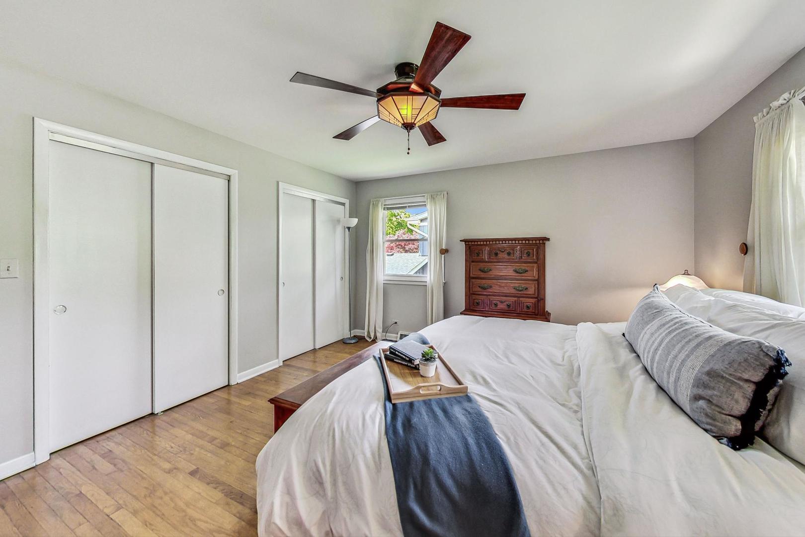 910 Whitegate Drive Mount Prospect, IL 60056 - Photo 22 of 38 a bedroom with a large bed and a chandelier