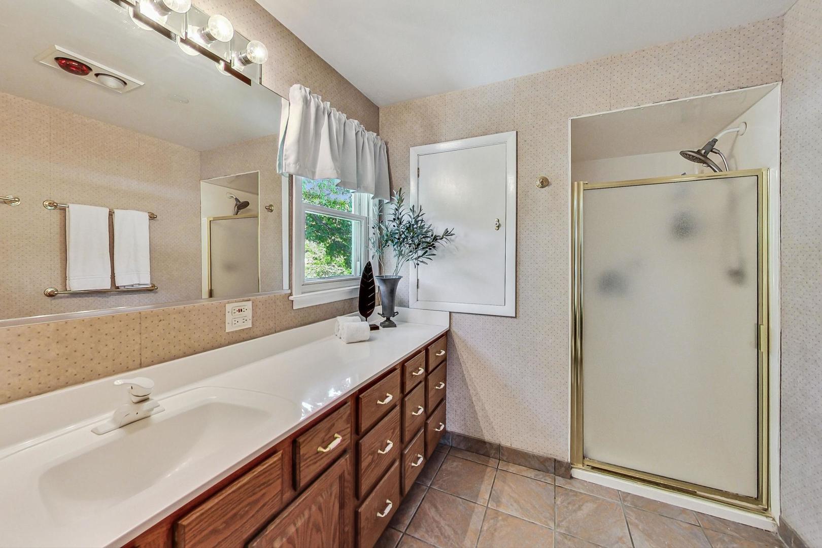 910 Whitegate Drive Mount Prospect, IL 60056 - Photo 24 of 38 a spacious bathroom with a double vanity sink mirror and shower