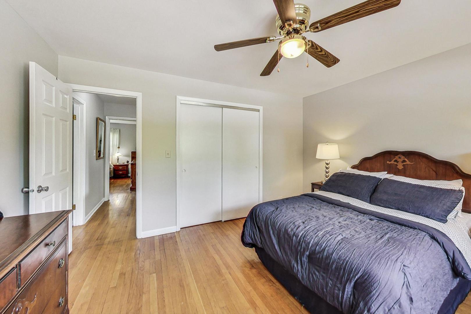 910 Whitegate Drive Mount Prospect, IL 60056 - Photo 26 of 38 a bedroom with a bed and a chandelier