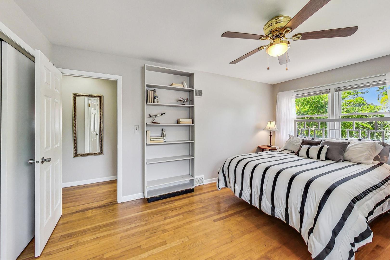 910 Whitegate Drive Mount Prospect, IL 60056 - Photo 28 of 38 a spacious bedroom with a bed and a ceiling fan