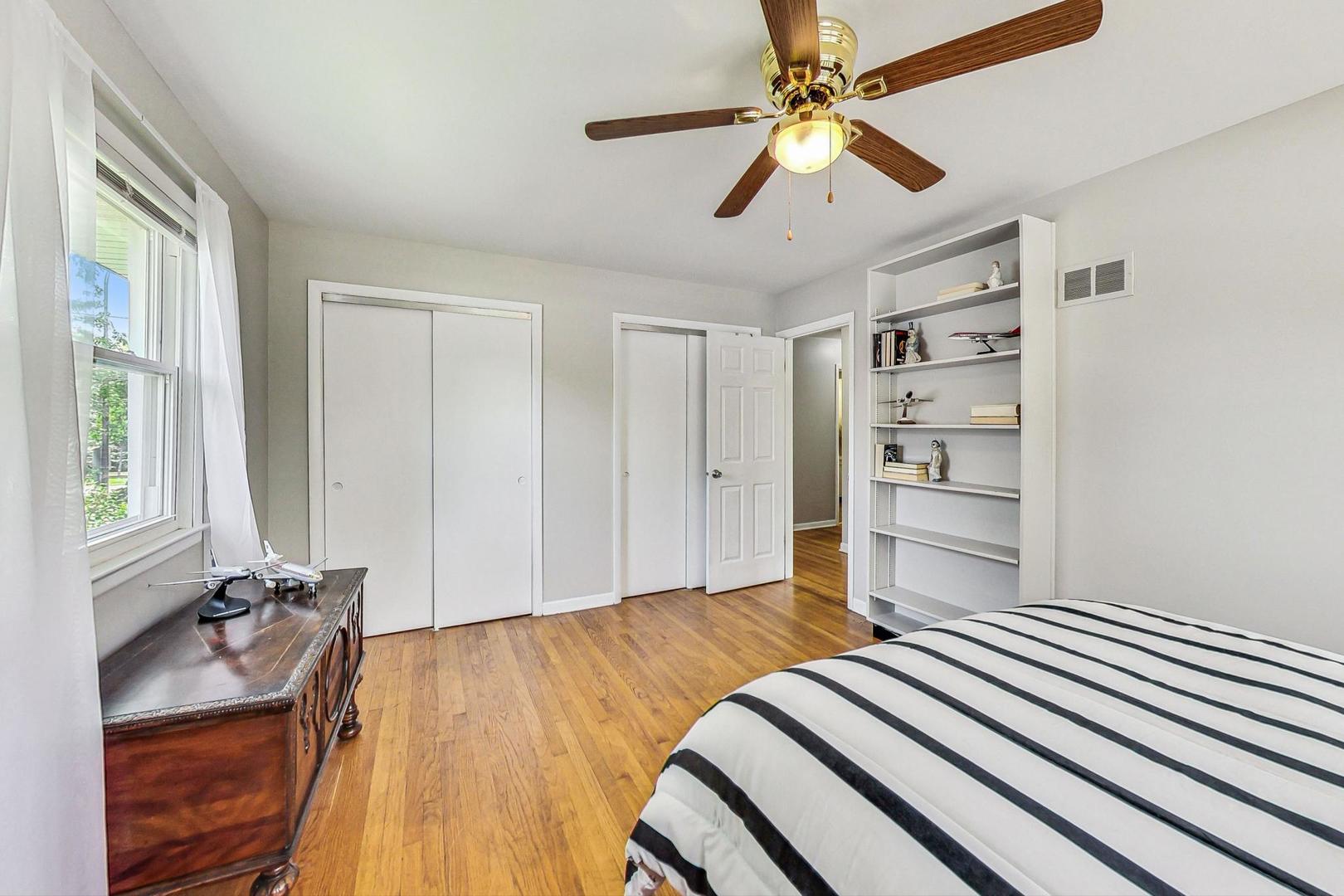 910 Whitegate Drive Mount Prospect, IL 60056 - Photo 29 of 38 a room with a bed and a chandelier