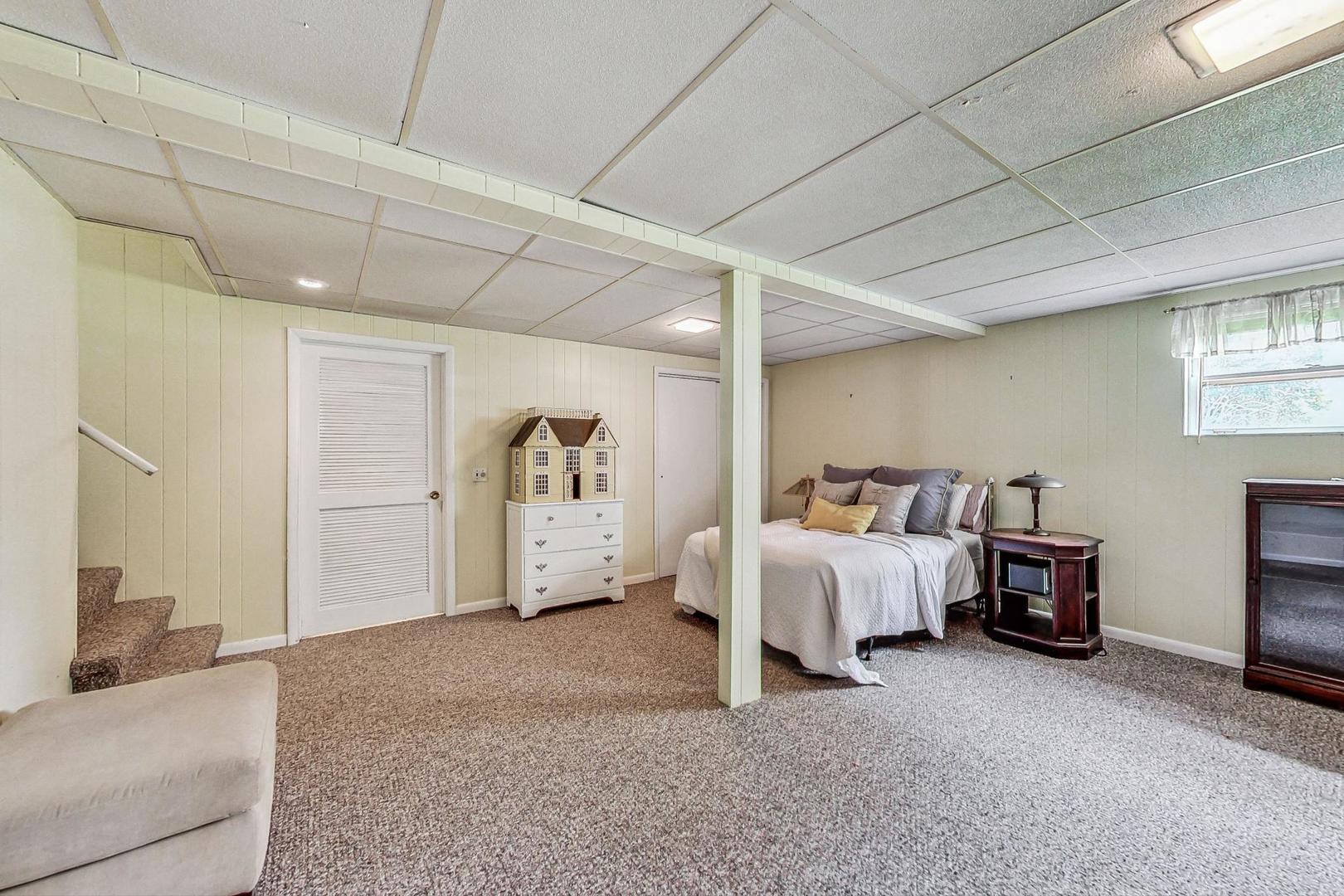 910 Whitegate Drive Mount Prospect, IL 60056 - Photo 32 of 38 a spacious bedroom with a bed and a couch