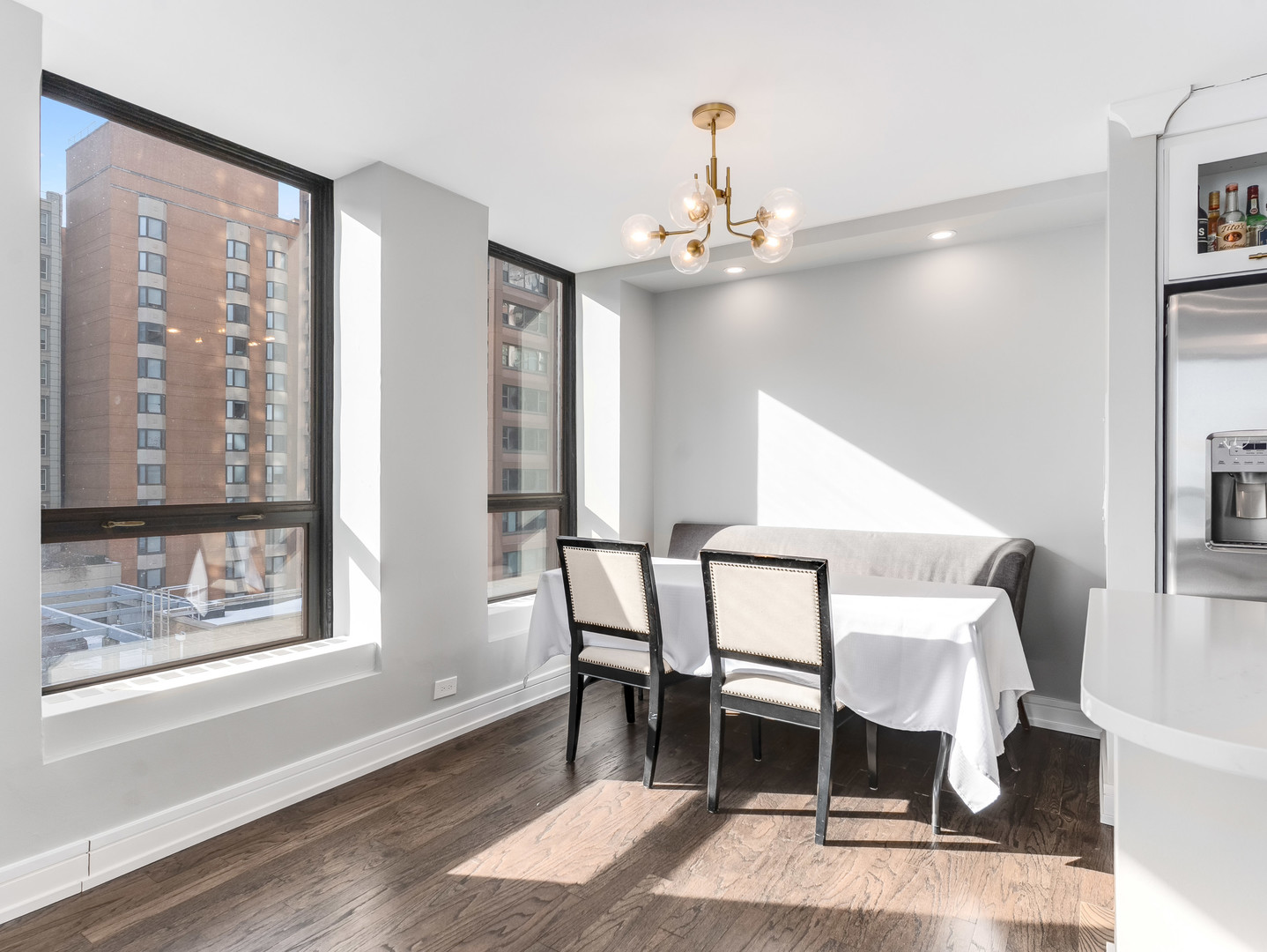 260 East Chestnut Street, Unit 1212 Chicago, IL 60611 - Photo 13 of 30 a view of a dining room with furniture and wooden floor