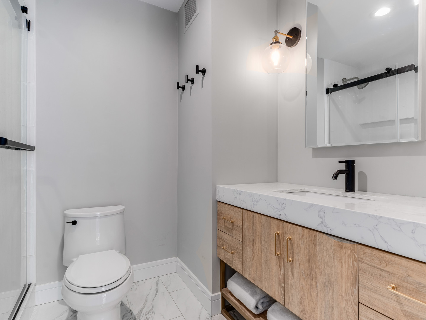 260 East Chestnut Street, Unit 1212 Chicago, IL 60611 - Photo 18 of 30 a bathroom with a granite countertop sink toilet and shower