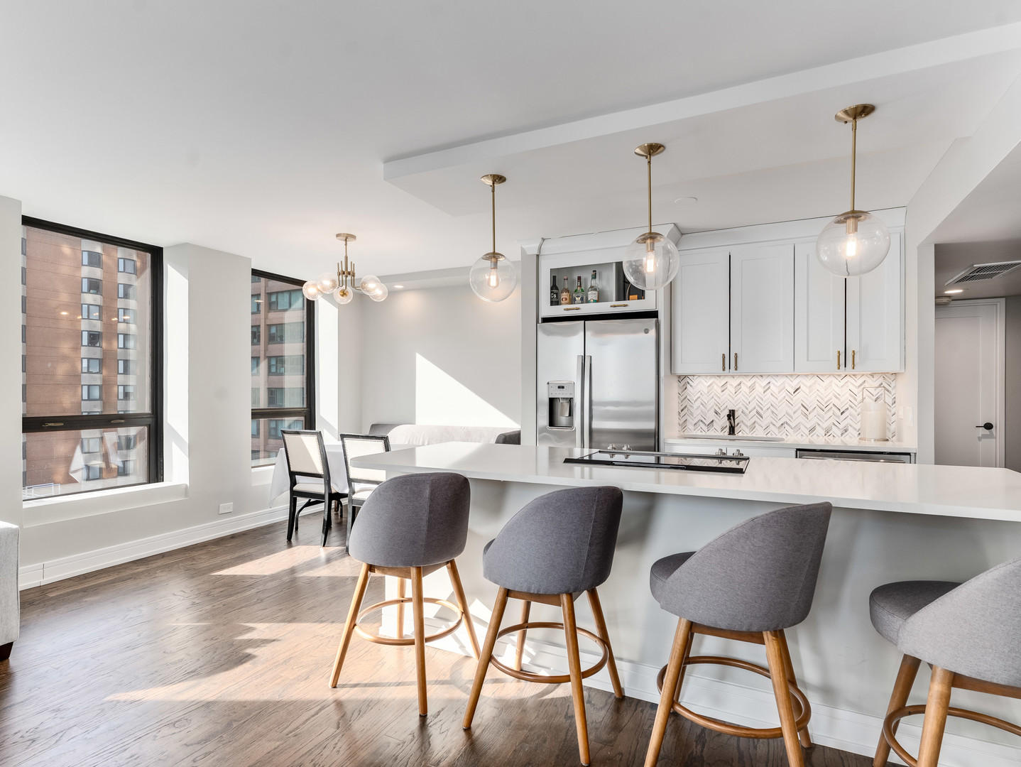 260 East Chestnut Street, Unit 1212 Chicago, IL 60611 - Photo 3 of 30 a kitchen with kitchen island a large window and chairs
