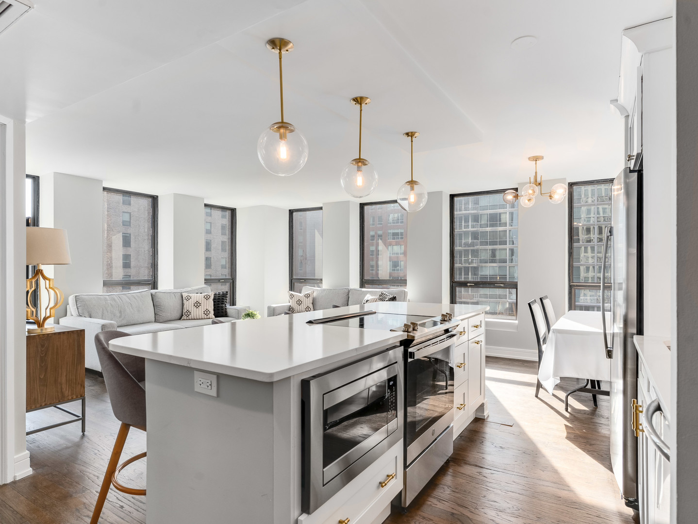 260 East Chestnut Street, Unit 1212 Chicago, IL 60611 - Photo 4 of 30 a large kitchen with kitchen island a large counter and a view of living room