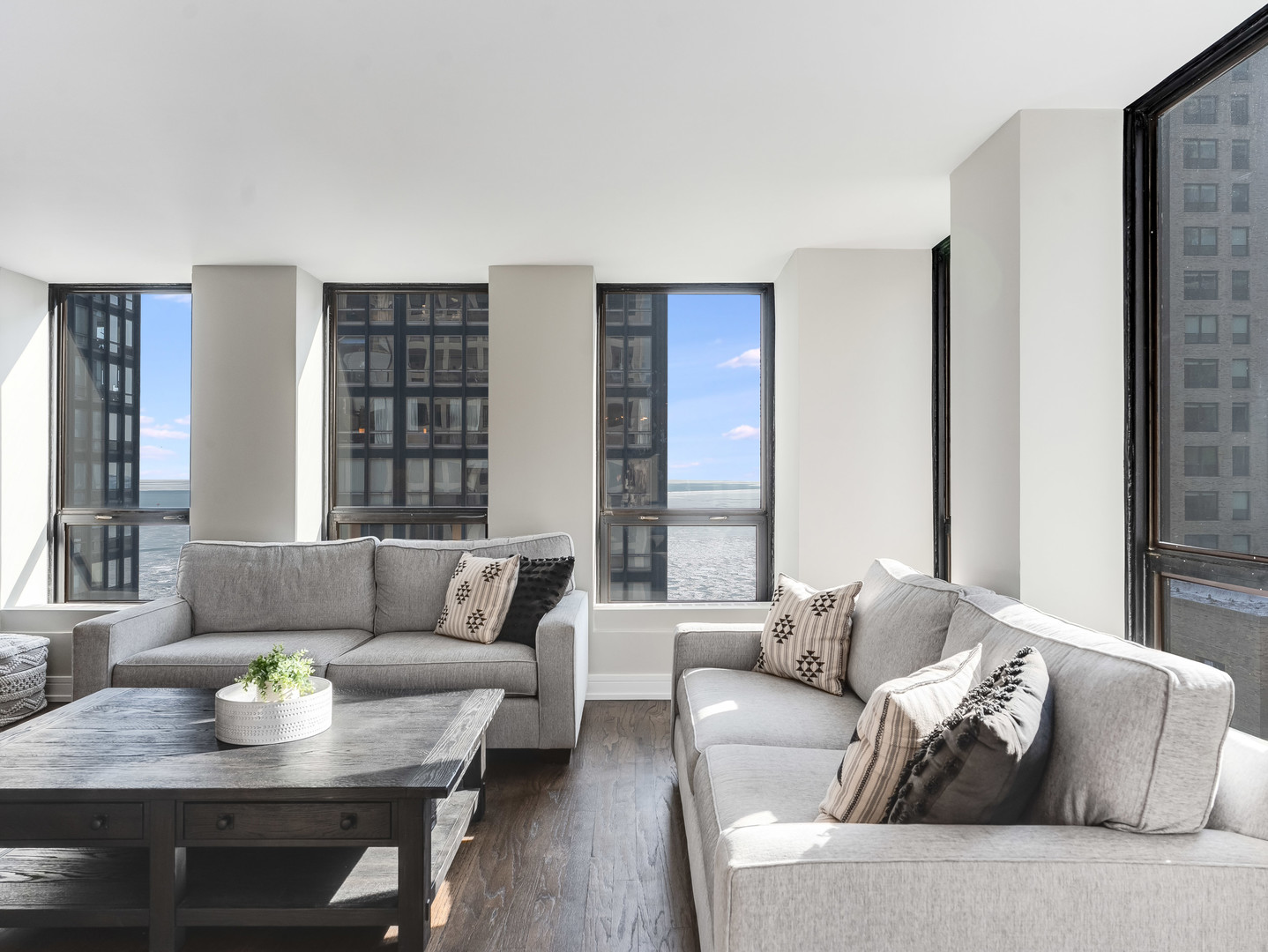 260 East Chestnut Street, Unit 1212 Chicago, IL 60611 - Photo 7 of 30 a living room with furniture and a large window