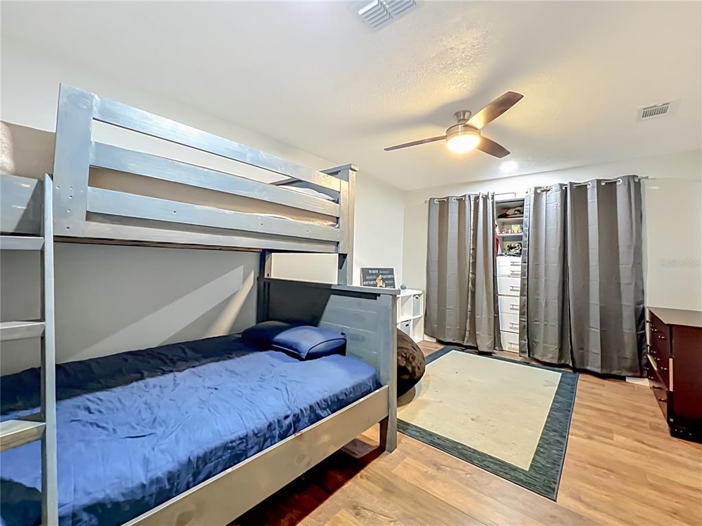153 Variety Tree Circle Altamonte Springs, FL 32714 - Photo 30 of 44 a bedroom with a bed a lamp and a large window