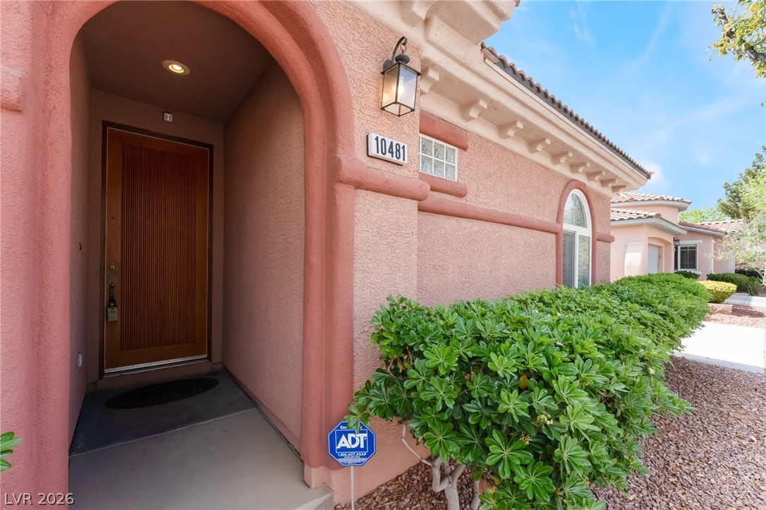 10481 Riverside Park Avenue Las Vegas, NV 89135 - Photo 5 of 51 View of exterior entry with stucco siding