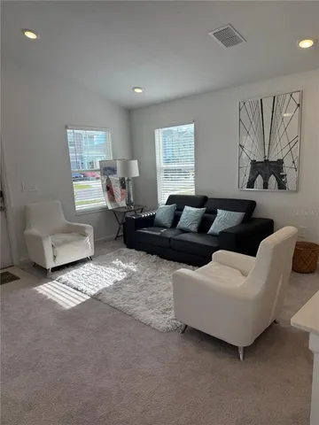 a living room with furniture and a window