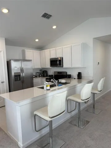 a kitchen with stainless steel appliances a refrigerator stove microwave and sink