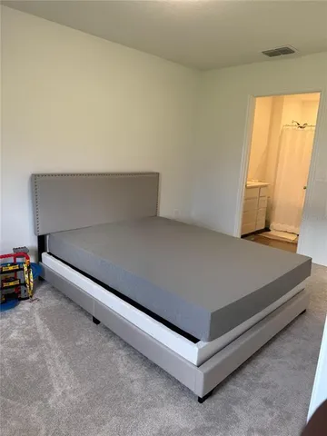 a living room with a bed and a window