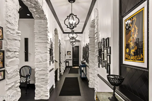 a view of a hallway with couches and wooden floor