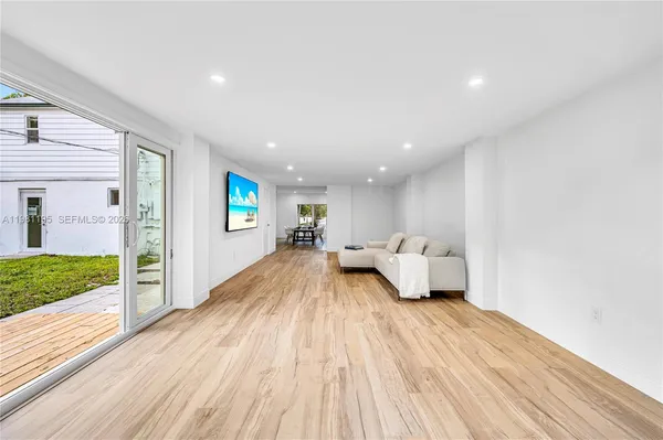 a dining room with furniture and wooden floor