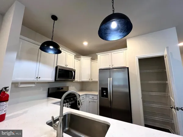 a kitchen with refrigerator and microwave