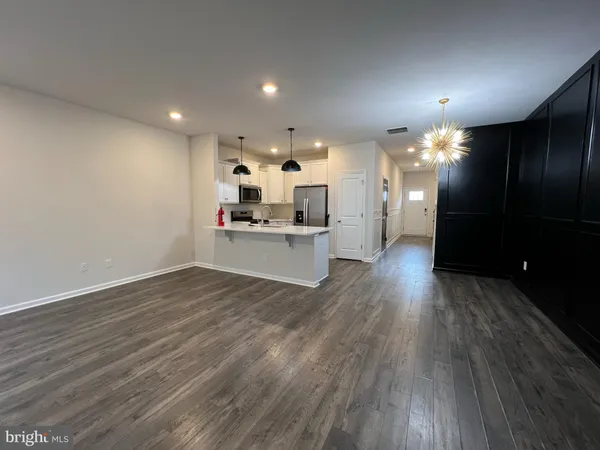 a view of a kitchen with a sink and a refrigerator