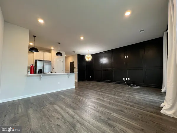 a view of a living room with kitchen