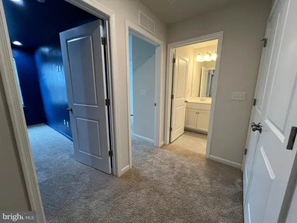 a view of a hallway with closet and wooden floor