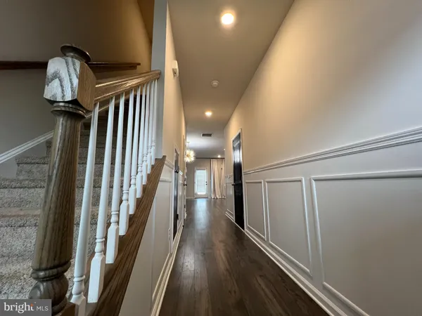 a view of entryway and gallery with wooden floor