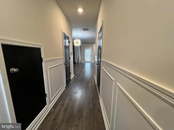 a view of hallway with wooden floor