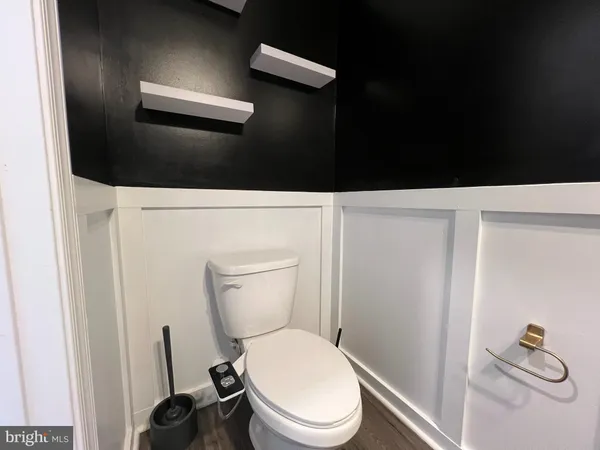 a bathroom with a toilet and a vanity