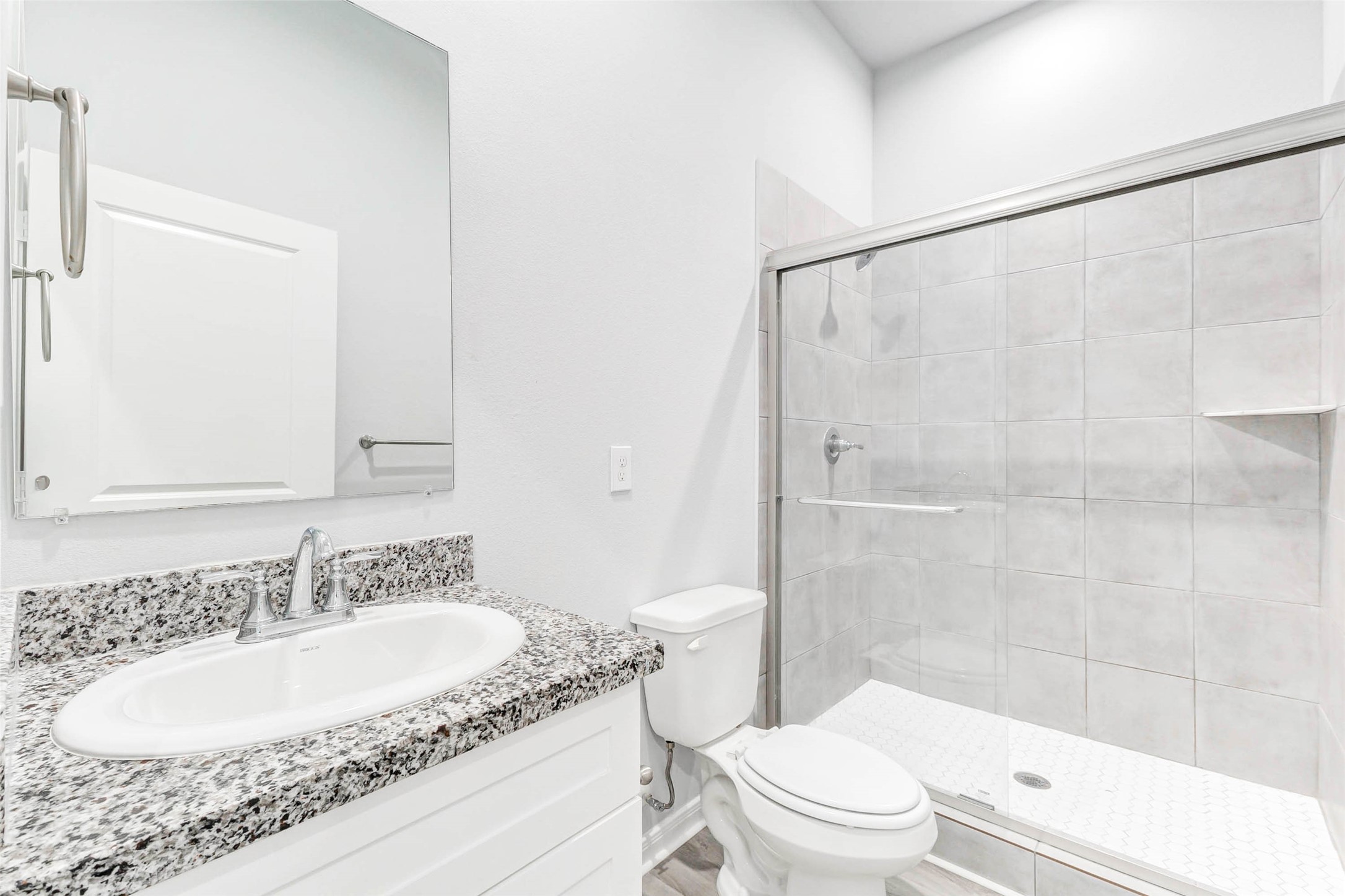 18835 Luminescent Ln Spring Spring, TX 77379 - Photo 14 of 28 a bathroom with a granite countertop sink toilet and shower