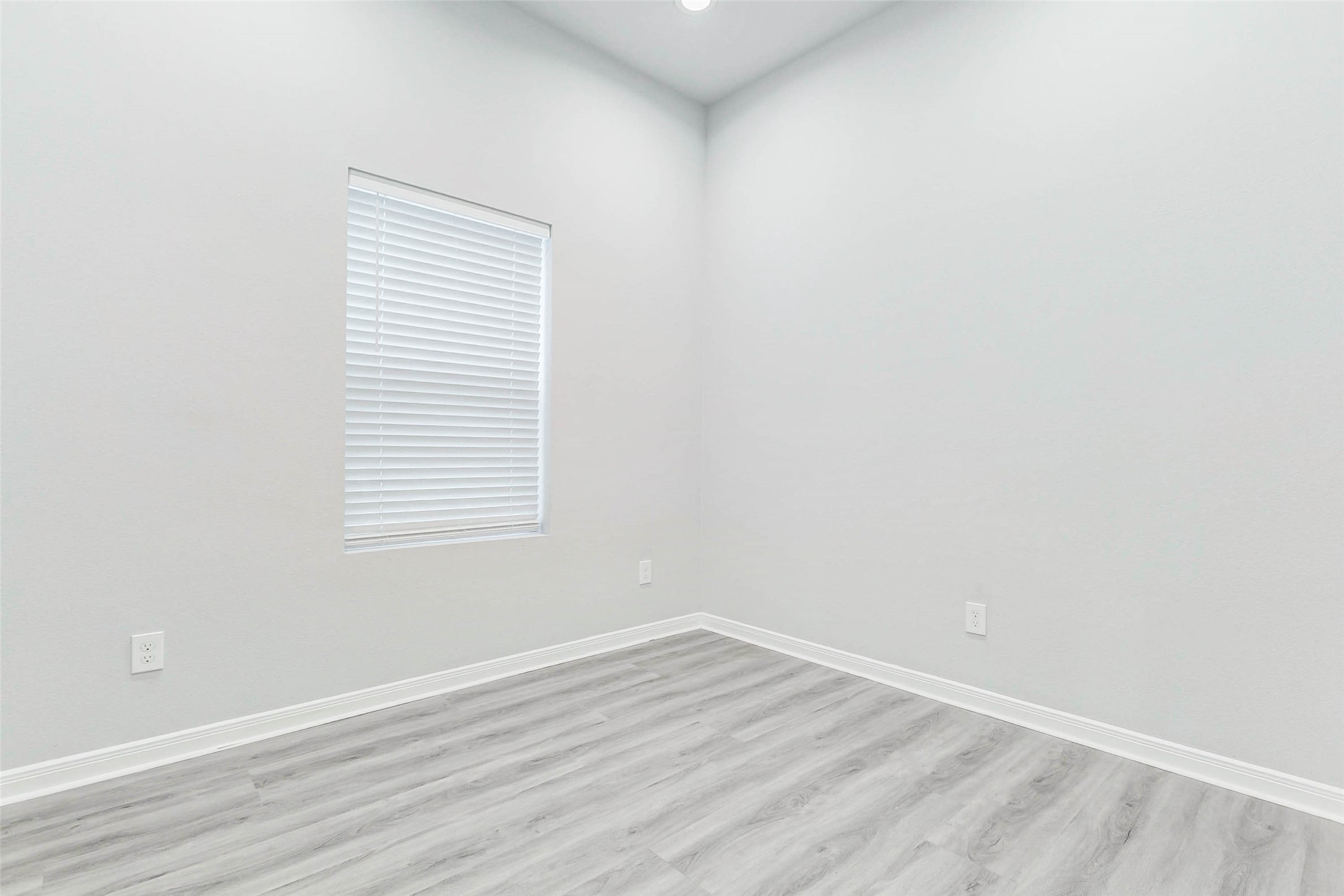 18835 Luminescent Ln Spring Spring, TX 77379 - Photo 16 of 28 a view of an empty room with wooden floor and a window