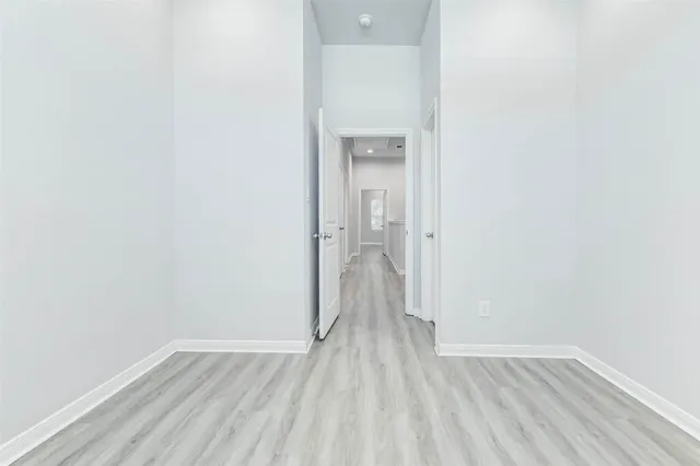 a view of a room with wooden floor
