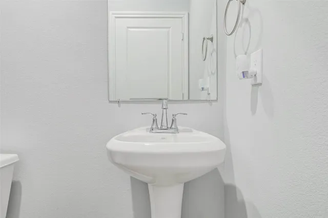 a bathroom with a sink a mirror and shower