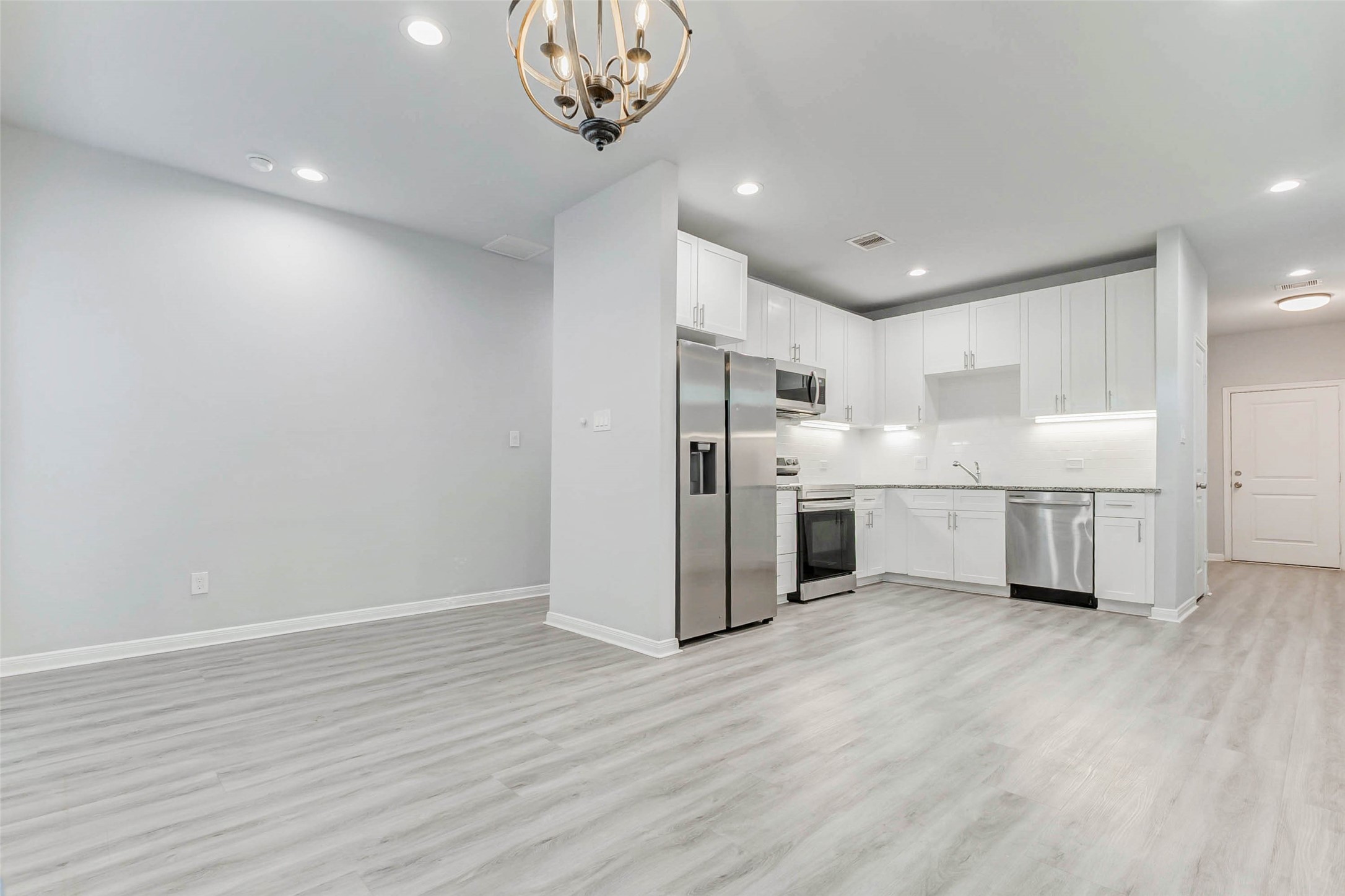 18835 Luminescent Ln Spring Spring, TX 77379 - Photo 5 of 28 a view of a kitchen with a refrigerator wooden floor and a sink