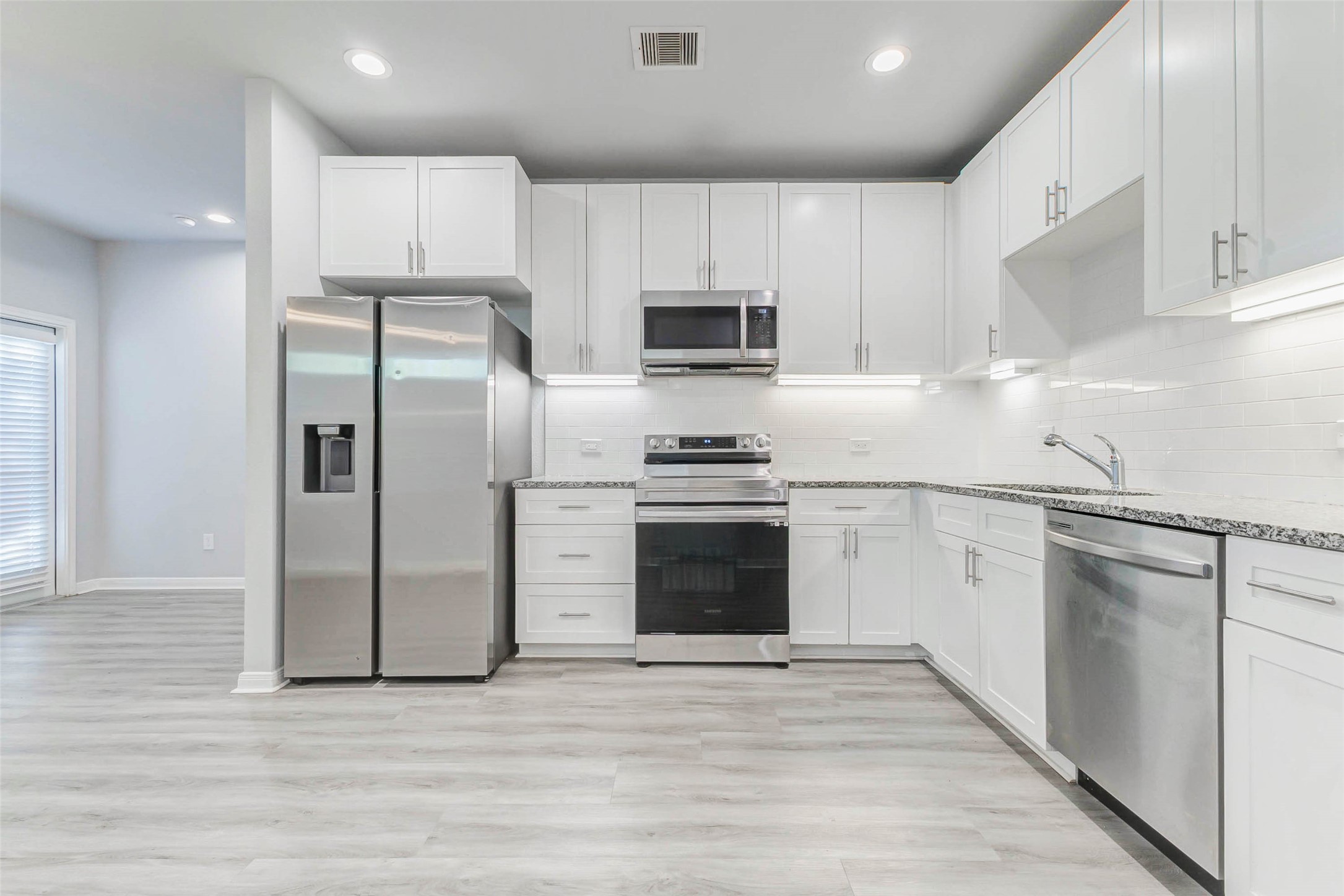 18835 Luminescent Ln Spring Spring, TX 77379 - Photo 6 of 28 a kitchen with stainless steel appliances a refrigerator stove and microwave