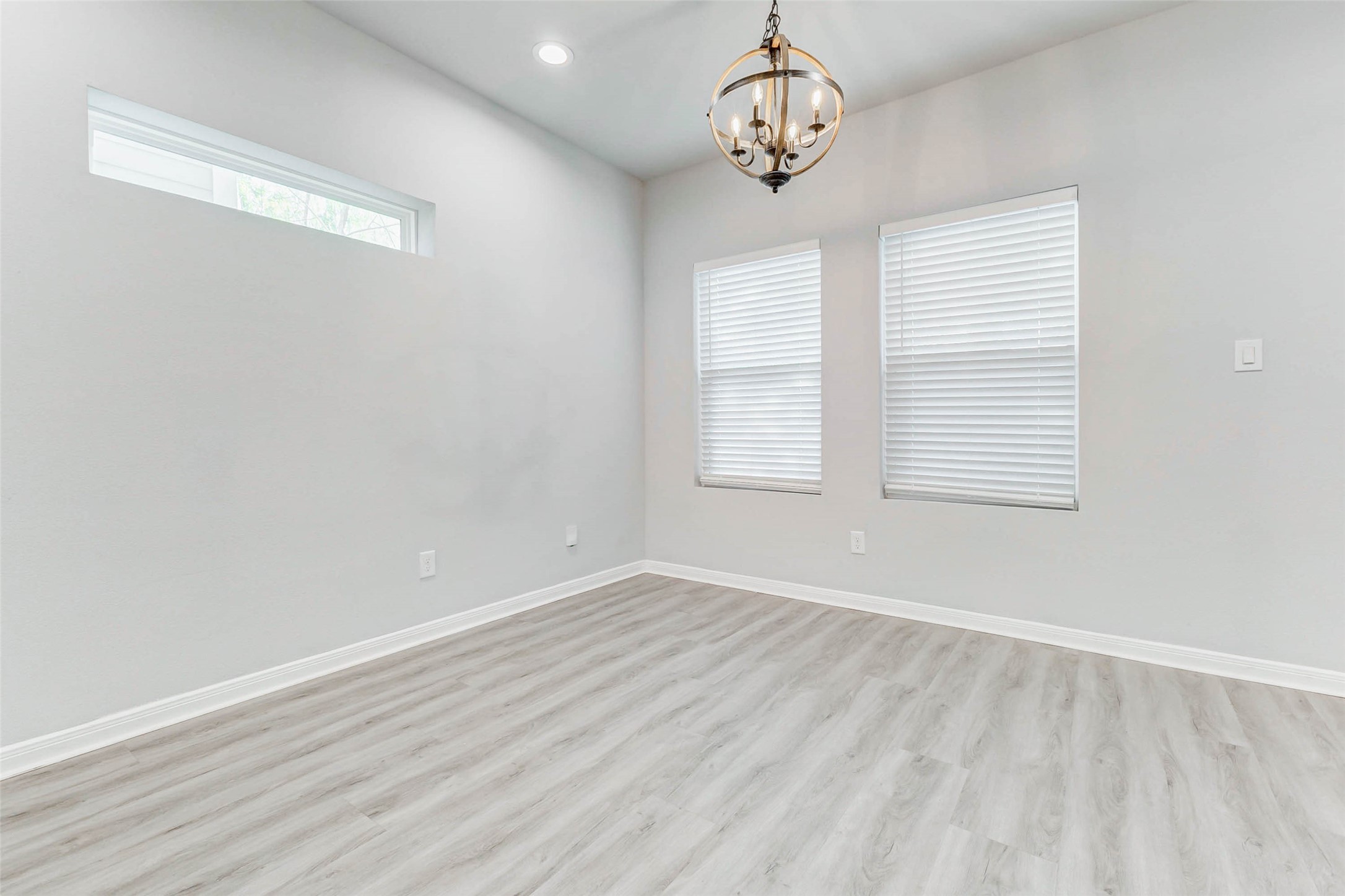 18835 Luminescent Ln Spring Spring, TX 77379 - Photo 7 of 28 an empty room with wooden floor and windows