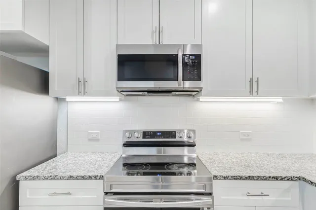 a stove top oven sitting inside of a kitchen