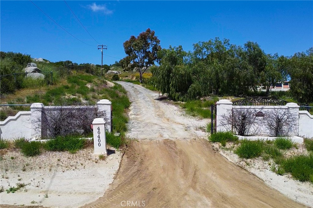 a view of a street with a house in the background