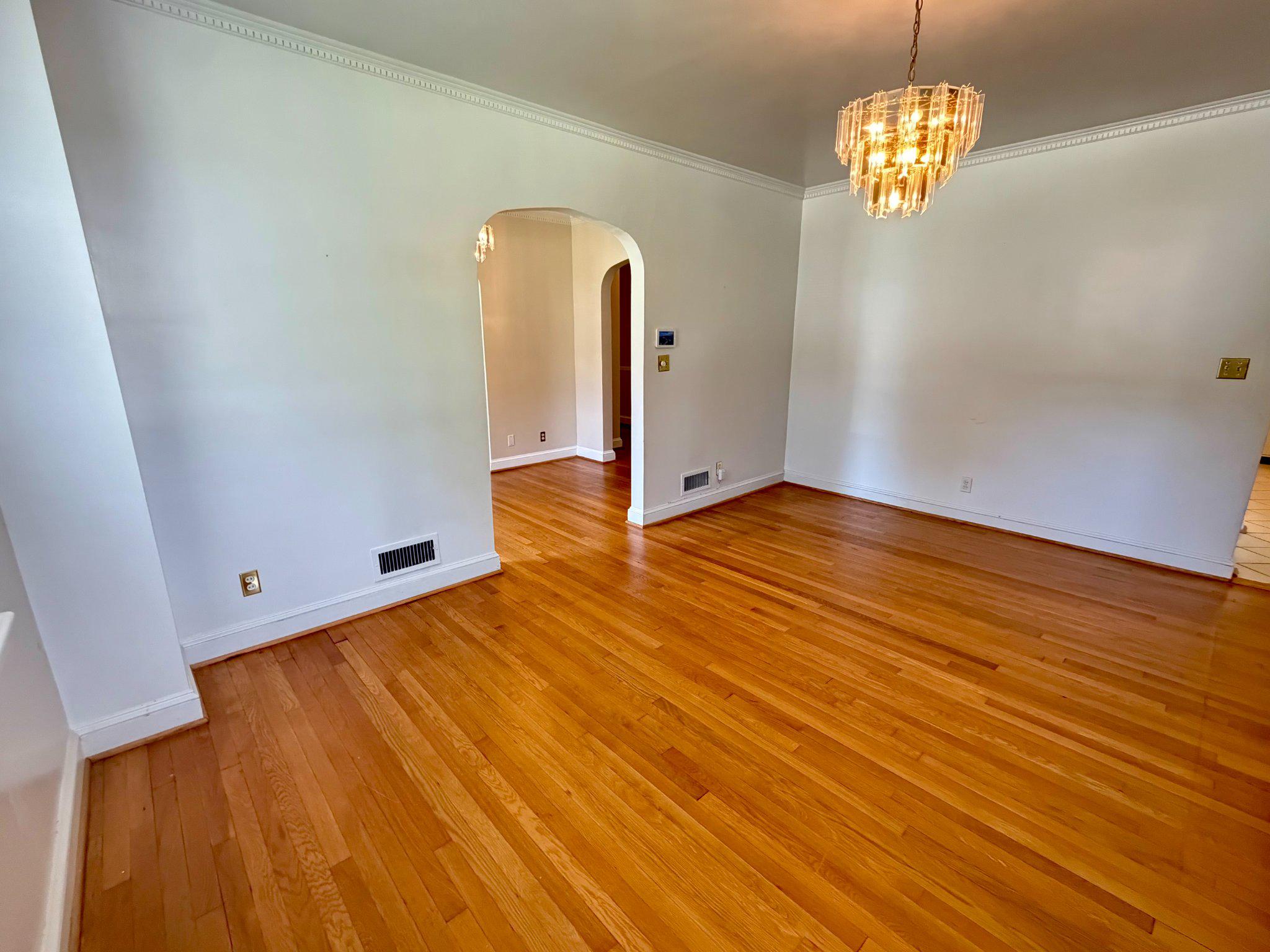 6318 Winner Avenue Baltimore, MD 21215 - Photo 16 of 75 a view of empty room with wooden floor and chandelier