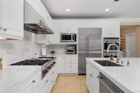 a stove top oven sitting inside of a kitchen