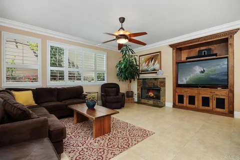 a living room with furniture and view of kitchen