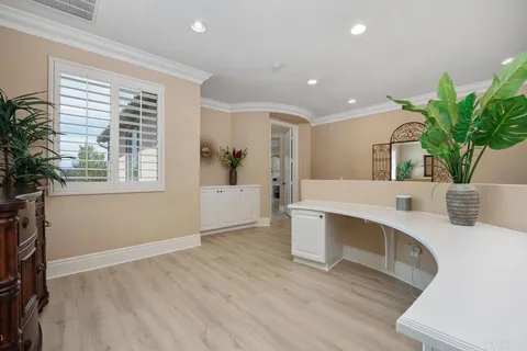 a spacious bedroom with a bed and a chandelier