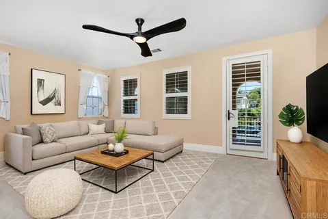 a living room with furniture a rug and a window