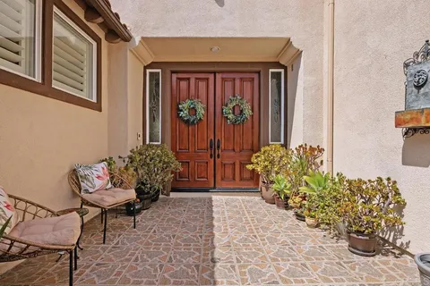 a front view of a house with outdoor seating