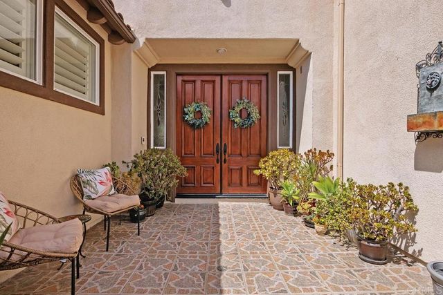 a front view of a house with outdoor seating