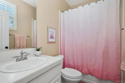 a bedroom with a bed closet and flat tv screen