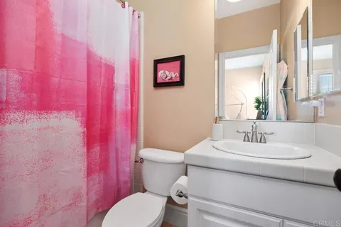 a patio with tables and chairs under an umbrella
