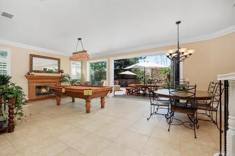 a living room with furniture a fireplace and a chandelier