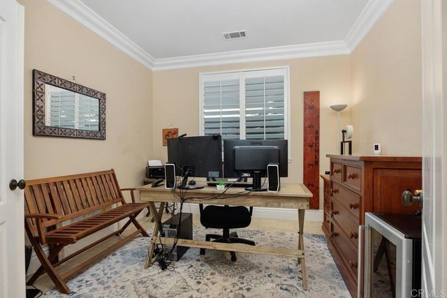 a kitchen with refrigerator and cabinets