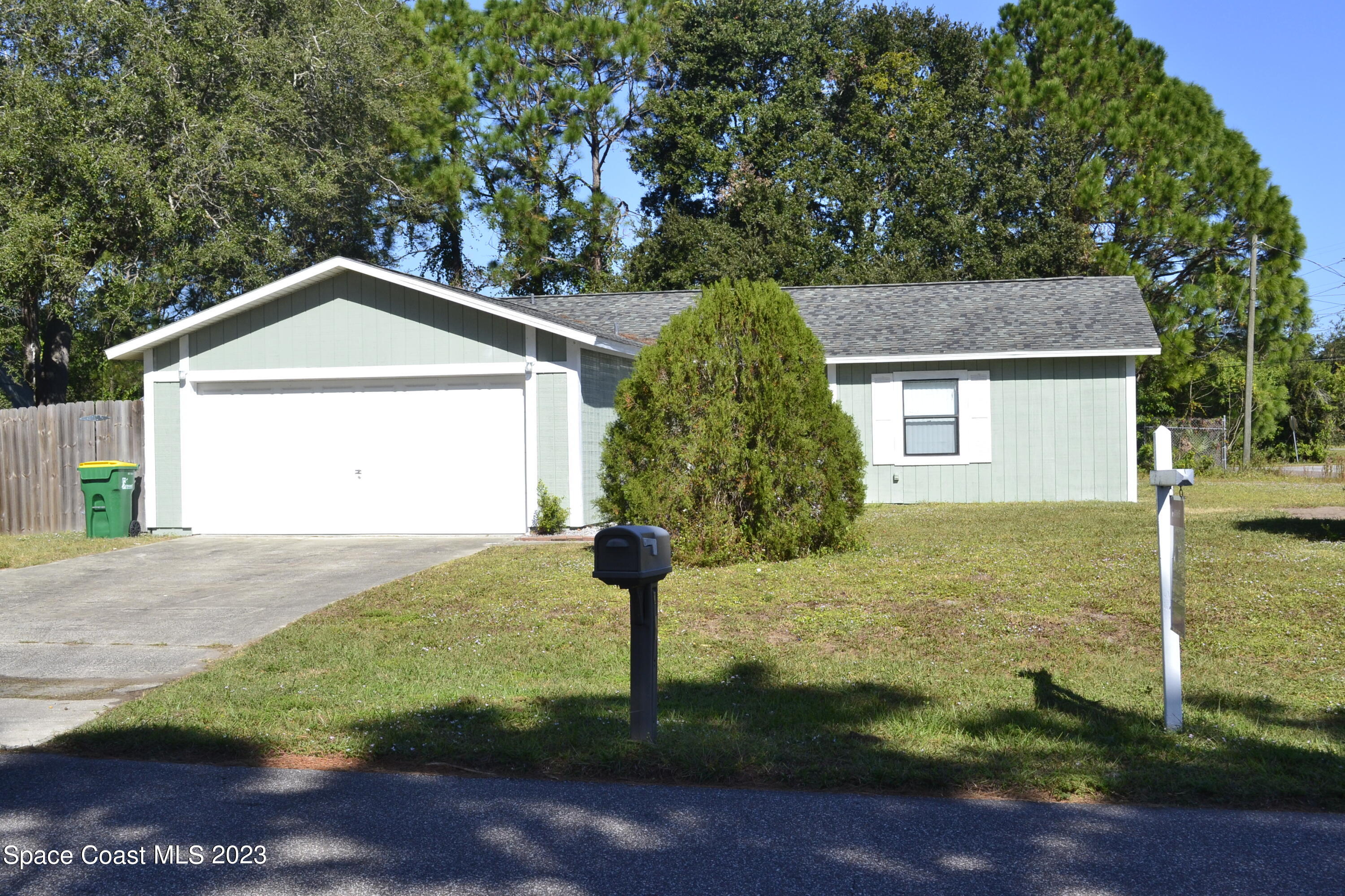 3910 Delespine Road Cocoa, FL 32927 - Photo 1 of 21 a house with trees in the background