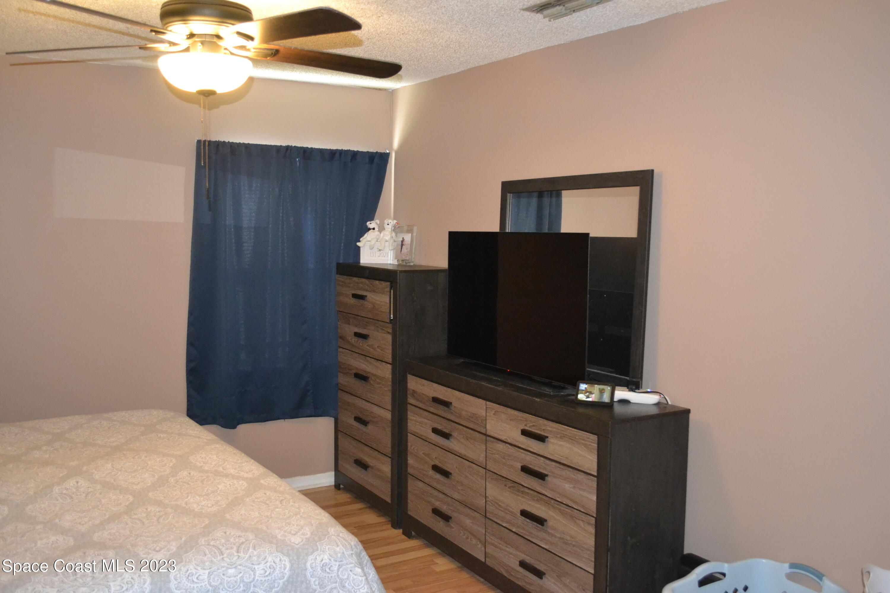 3910 Delespine Road Cocoa, FL 32927 - Photo 13 of 21 a bedroom with a bed and a dresser