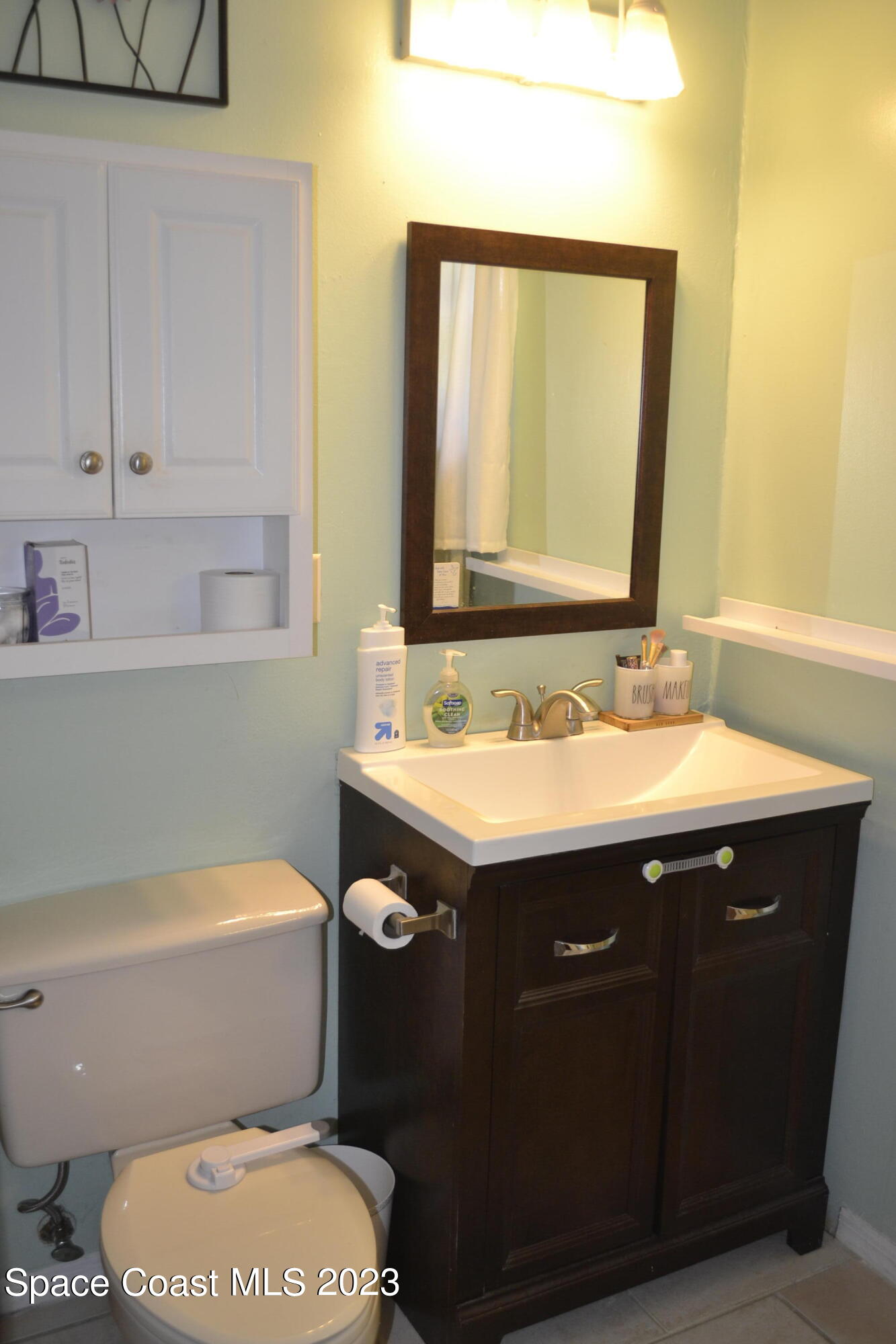 3910 Delespine Road Cocoa, FL 32927 - Photo 14 of 21 a bathroom with a granite countertop toilet sink and mirror