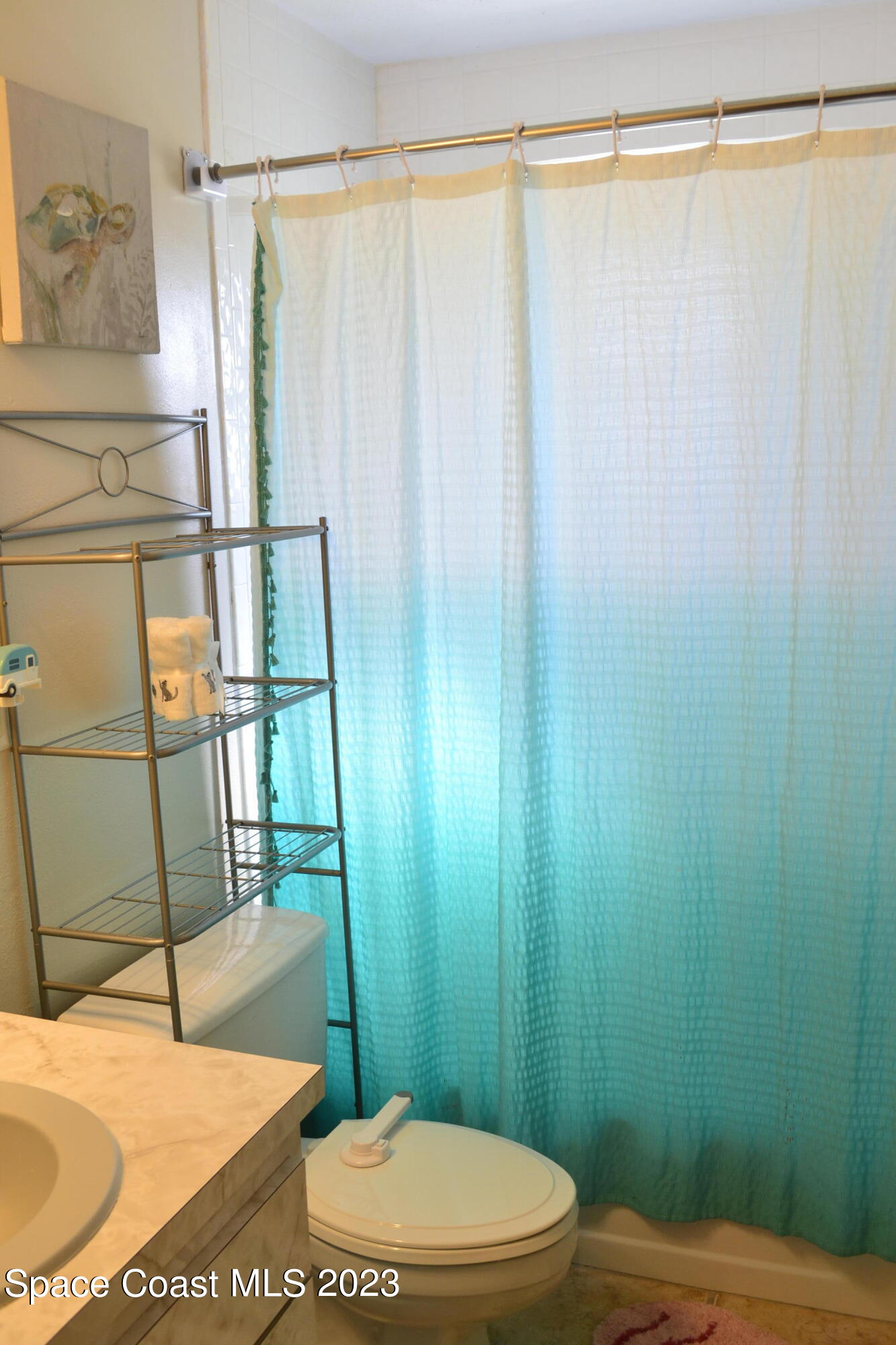 3910 Delespine Road Cocoa, FL 32927 - Photo 16 of 21 a bathroom with a toilet and a shower